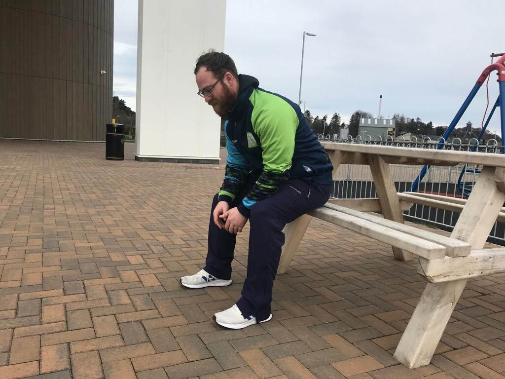 a picture of one the team members sitting on a bench