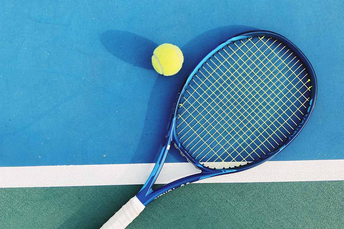tennis racket and tennis ball on court