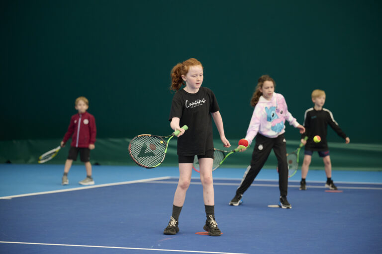 Kids tennis sessions at moray sports centre - a picture showing some young kids playing tennis